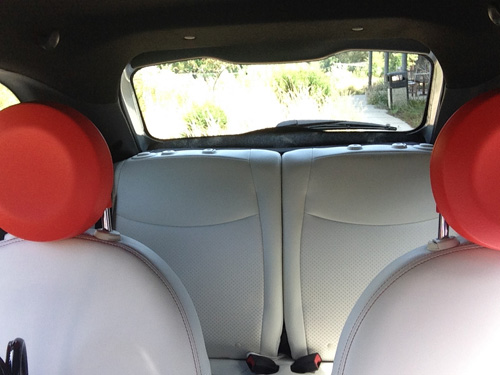 Fiat 500e back seat seen from the front seat.