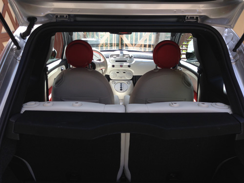 View of the Fiat 500e from the trunk of the back seat, front seat and dash.