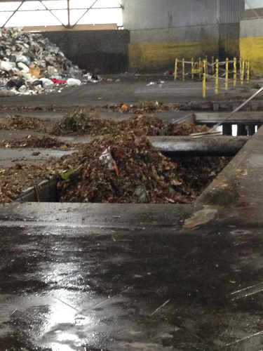 Moving the compost piles into the underground dump truck (headed for the landfill).