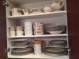 The best way to optimize space in your cabinets is use shelf risers. It also makes it easy to access dishes.